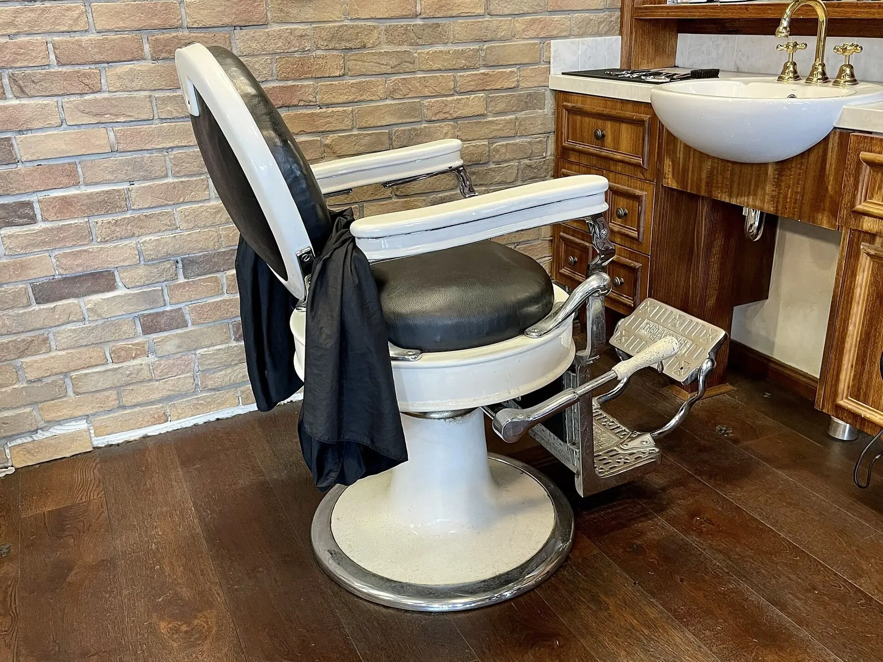 A restored hydraulic chair by the basin