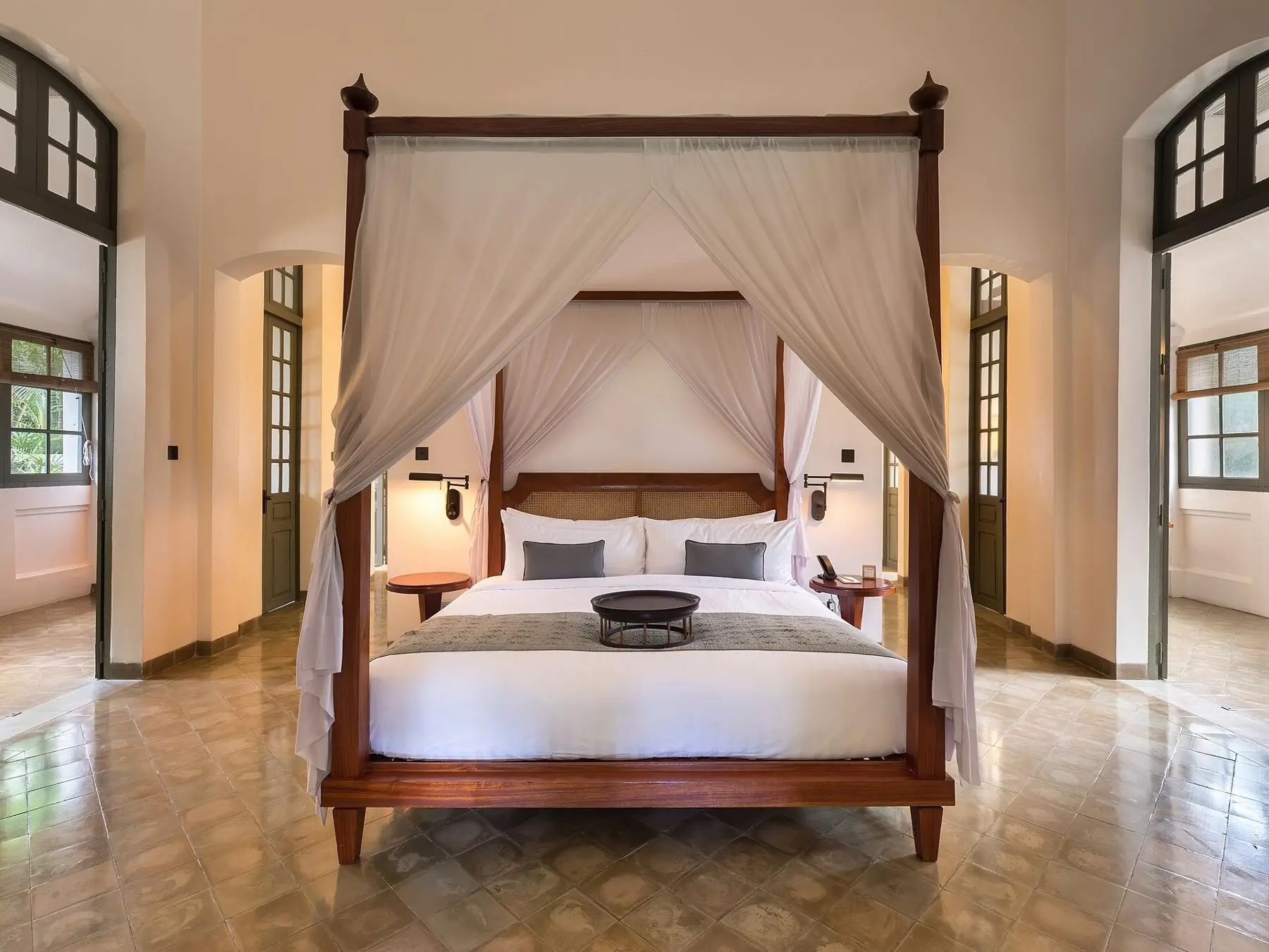 A canopy bed on the original tiled floor